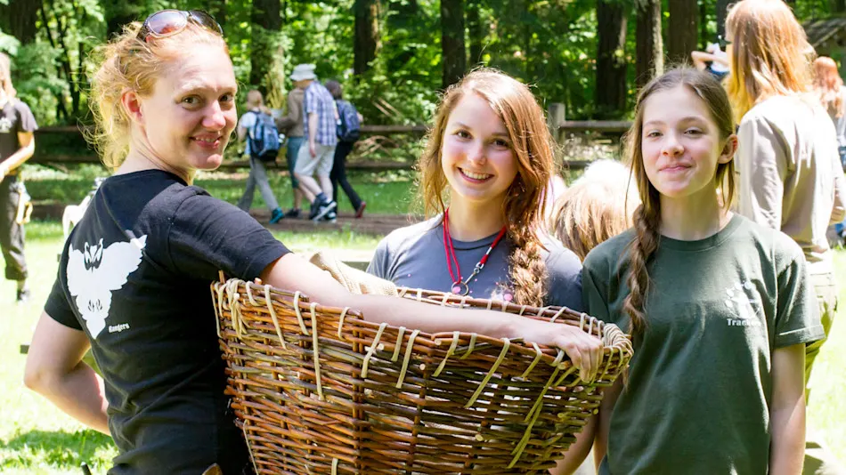 Teen leaders carrying a woven basket