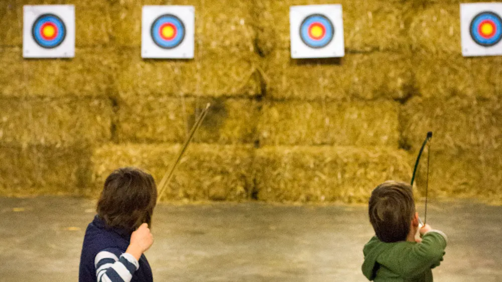 Archers shooting at targets on the Trackers indoor range