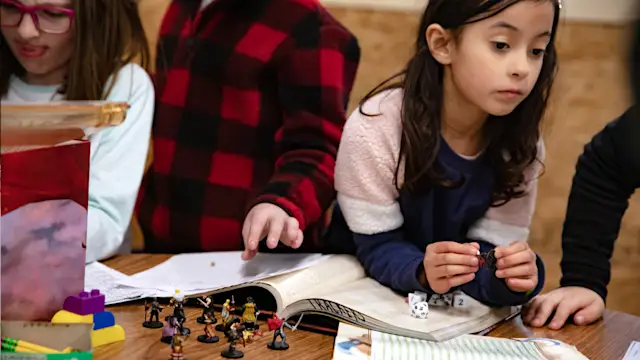 Kids playing a role-playing game with a Guide