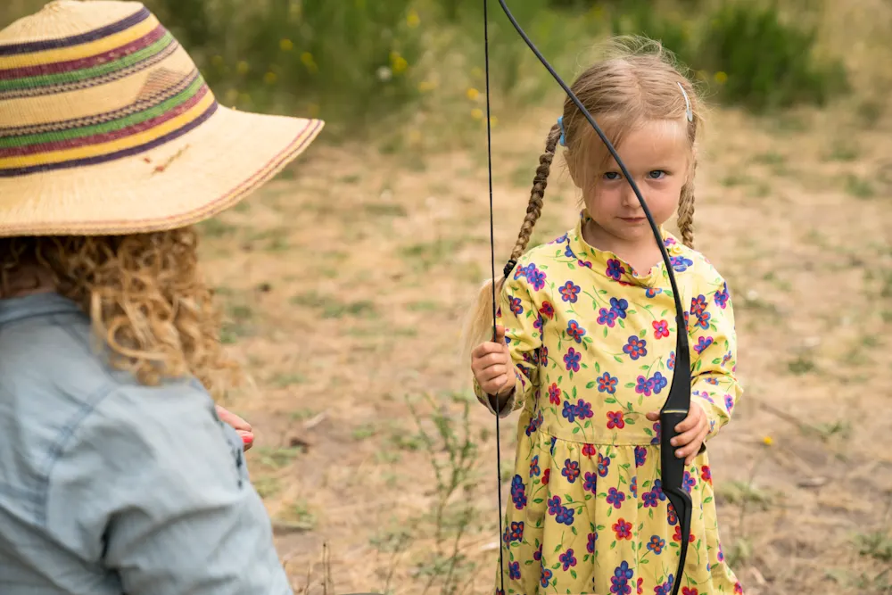 Young Rovers on the archery line with a Trackers Guide