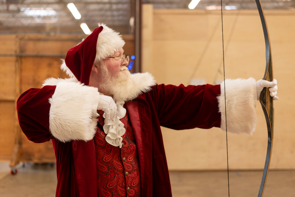Santa Claus drawing a longbow on the Trackers archery range