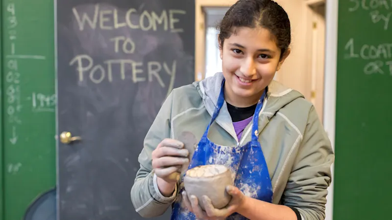 Camper showing her pinch pot in the Trackers pottery studio