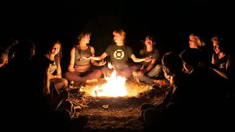 Teens around the campfire at overnight camp
