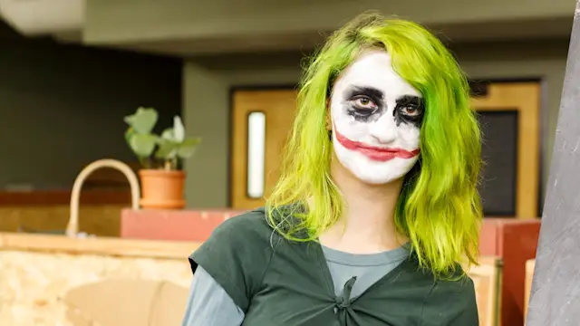 Trackers Guide in green-haired Joker makeup at Track-or-Treat