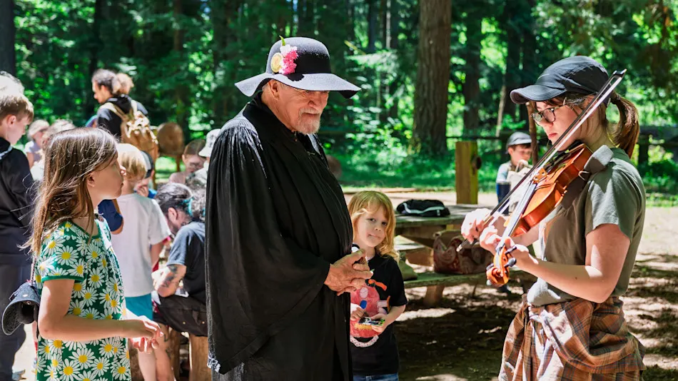 Costumed Guide with kids at the Goblin Market