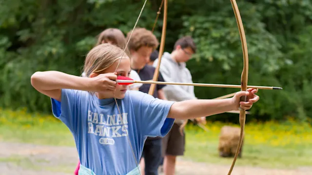 Teen homeschool leaders at the archery range