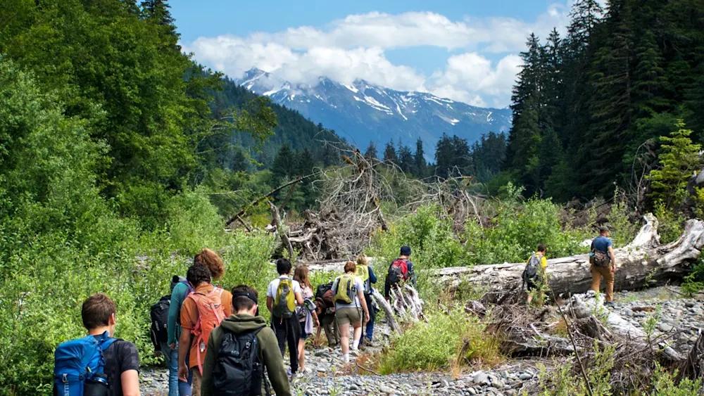 Teens hiking into the mountains on expedition