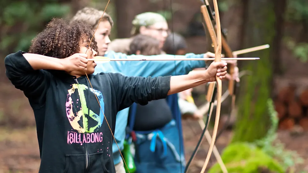Campers practicing archery with Trackers Guides