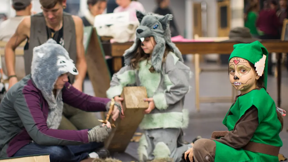Kids in wolf costumes performing at a Trackers Halloween party