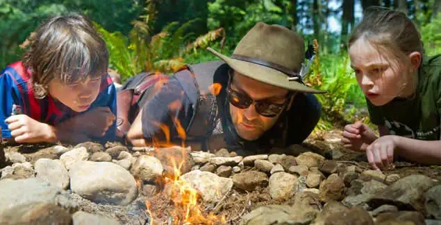 Student making fire with a Trackers Guide