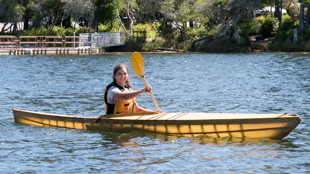 Camper paddling a kayak on the river