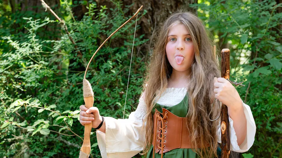 Costumed Trackers kid with a bow at the Goblin Market